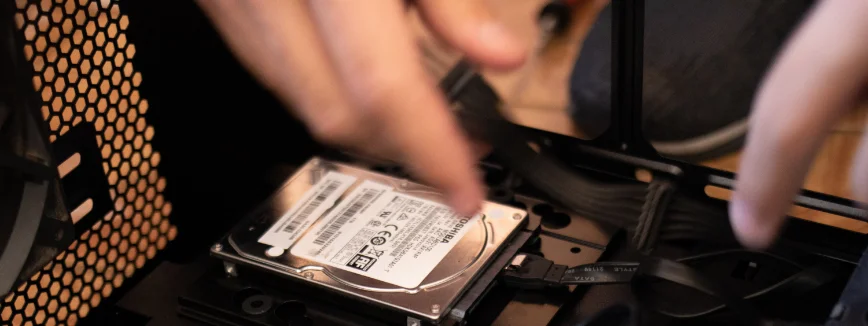 Drop off computer repair technician working on inside of laptop